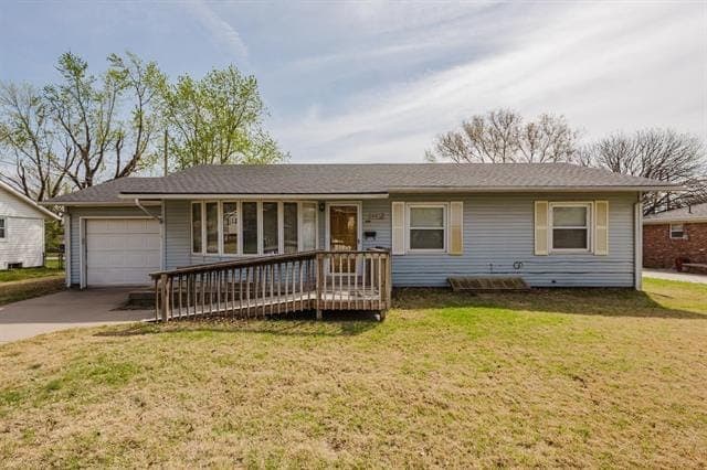 Ranch house with pale siding and a wooden ramp, before renovation