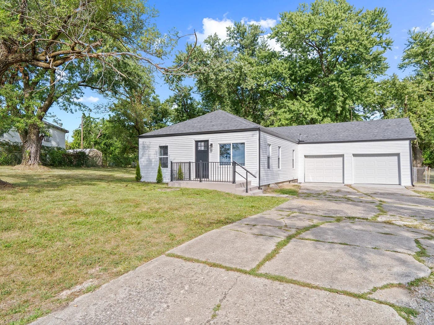 White ranch house with a detached two-car garage
