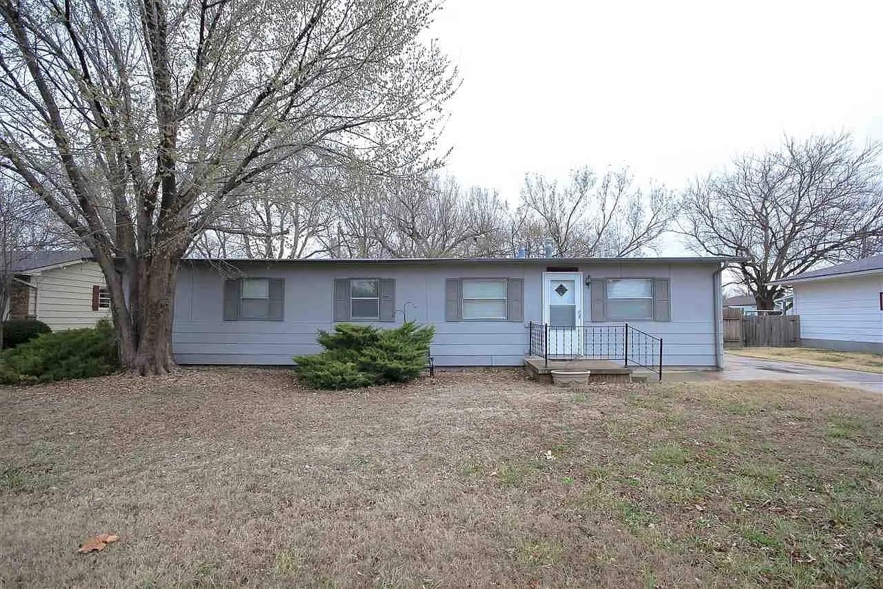 Ranch house under bare winter trees