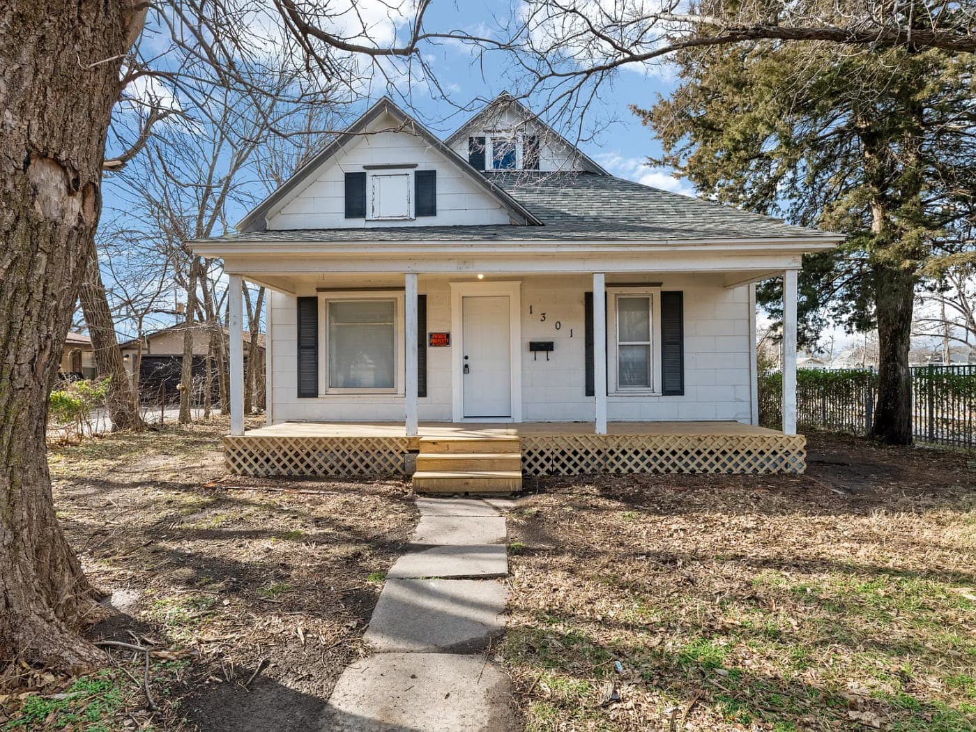 White farmhouse-style house with a front porch